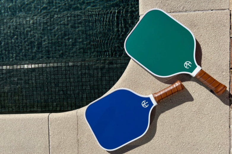 Blue pickleball paddle and green pickleball paddle