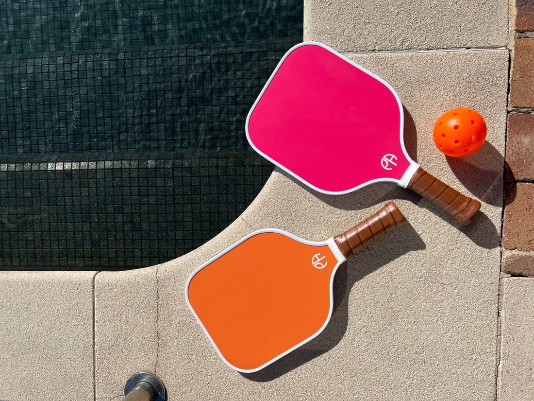 pickleball paddles and ball lying on ground