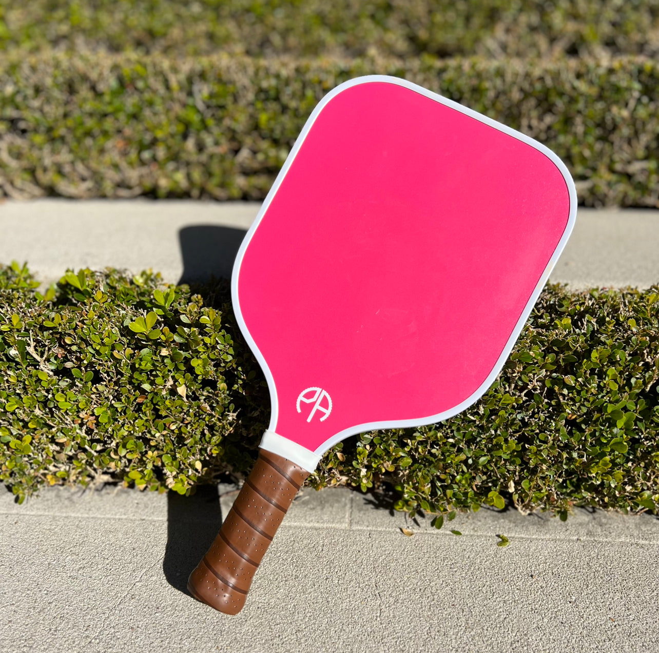 Pink pickleball paddle on a blue lounge